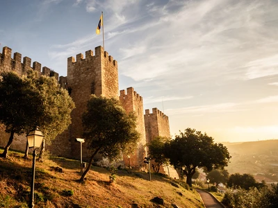 Castelo de Sao Jorge in Lisbon, Moorish castle ramparts and watchtowers above the Alfama district at golden hour