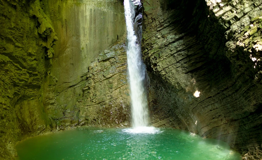 A 15-meter limestone-amphitheater waterfall on the Soca River near Kobarid